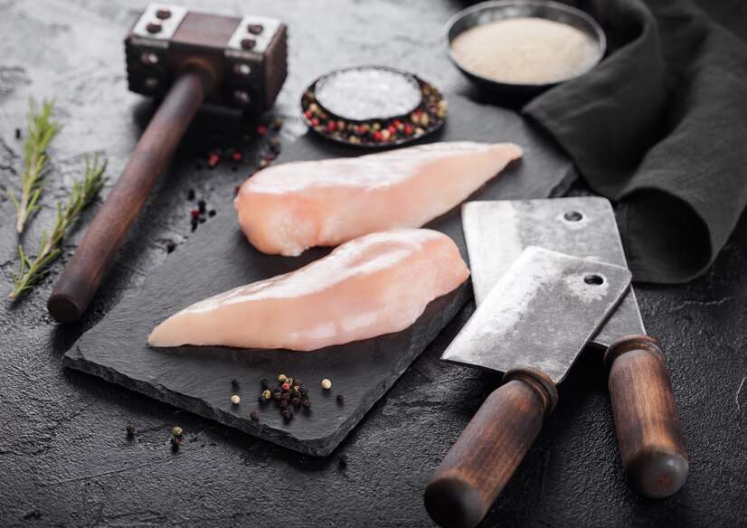 fresh-raw-organic-chicken-fillet-breast-on-black-stone-board-with-meat-hatchets_157173-1969.jpg