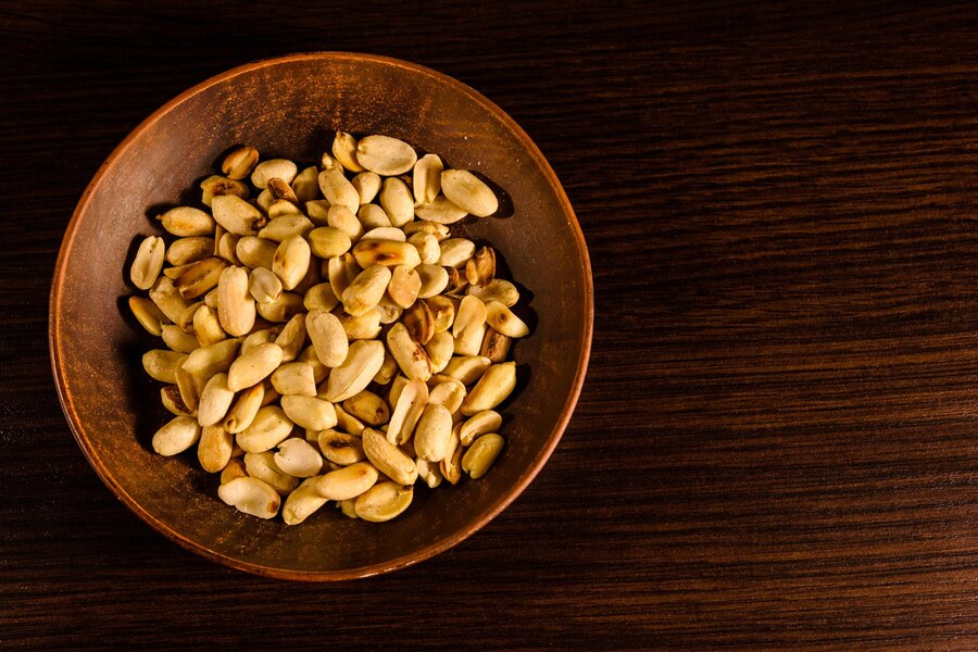 peeled-roasted-peanuts-in-ceramic-dish-on-wooden-table-top-view_508659-6131.jpg